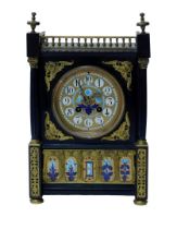 An early 20thC Aesthetic movement clock, in a Gothic Revival case, with painted enamel dial with