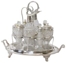 A George III silver cruet stand, the central handle decorated with a lower band of leaves, on four