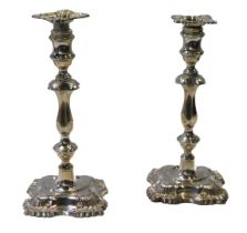 A pair of George V loaded silver candlesticks, with leaf cast decoration, William Hutton and Sons