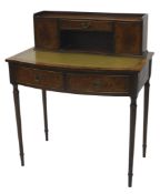 A Victorian style mahogany and walnut writing desk, the three part galleried top raised above an