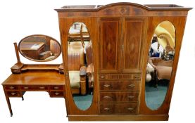 An Edwardian mahogany bedroom pair, comprising a boxwood strung and part inlaid triple wardrobe,