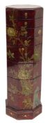 A Chinese red and black tiered box, of octagonal form, with eight graduated trays, decorated with