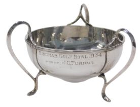 A George V silver three handled bowl, of shaped circular form, on hoof feet, marked Bingham Golf