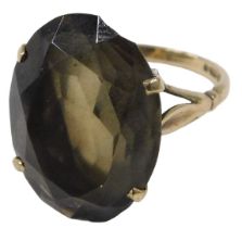 A 9ct gold smokey quartz dress ring, set with oval cut smokey quartz, in a raised four claw basket