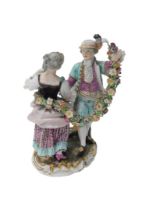 A late 19th/early 20thC Meissen porcelain figure group, of a male and female dancing, holding a