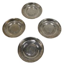 Four silver dishes, inset with European coins, to include Theresa style, unmarked white metal,