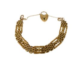 An elaborate gate bracelet, of four bar brushed design, with ball and bar links, with rose gold