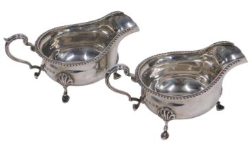 A pair of Elizabeth II silver sauce boats, each with ear handles and triple hoof feet, by Adie
