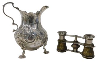A Victorian silver cream jug, with flared rim, acanthus leaf ear handle, bulbous, repousse decorated
