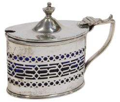 A George V silver mustard pot, of oval form, with urn finial, thumb mould handle and part pierced