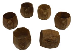 A set of six Robert 'Mouseman' Thompson of Kilburn napkin rings, of octagonal form, each carved with