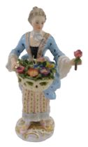 A 19thC German Meissen porcelain figure of a lady, dressed in finery holding basket of flowers, on a