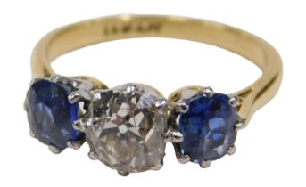 A diamond and sapphire three stone dress ring, with old cushion cut diamond, 6mm x 5.2mm x 4.4mm,