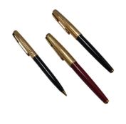 Three Parker Pens, comprising two fountain pens, each with a gold-coloured lid, one in black, the