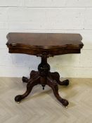A Victorian burr walnut serpentine shaped fold over top card table