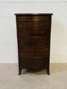 A tall and narrow 1920's mahogany bowfront chest