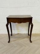 A 1940's bow fronted walnut cased 'Viners' canteen of cutlery table