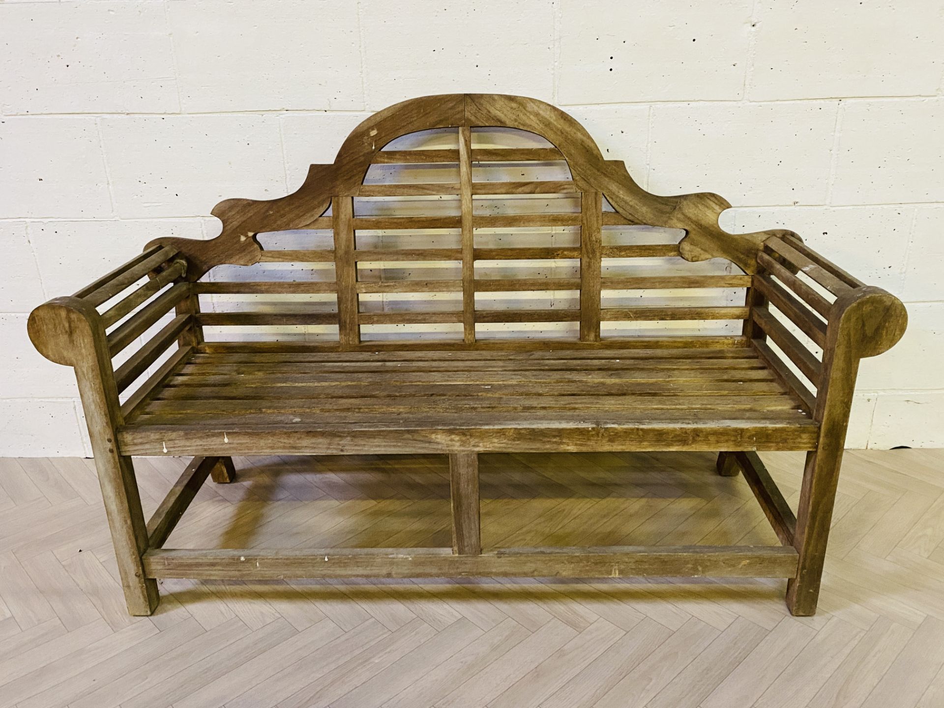 An attractive large hardwood 'Lutyens' style garden bench of typical style and form