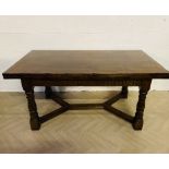 A large good quality 18th style heavy solid oak drawer leaf extending dining table