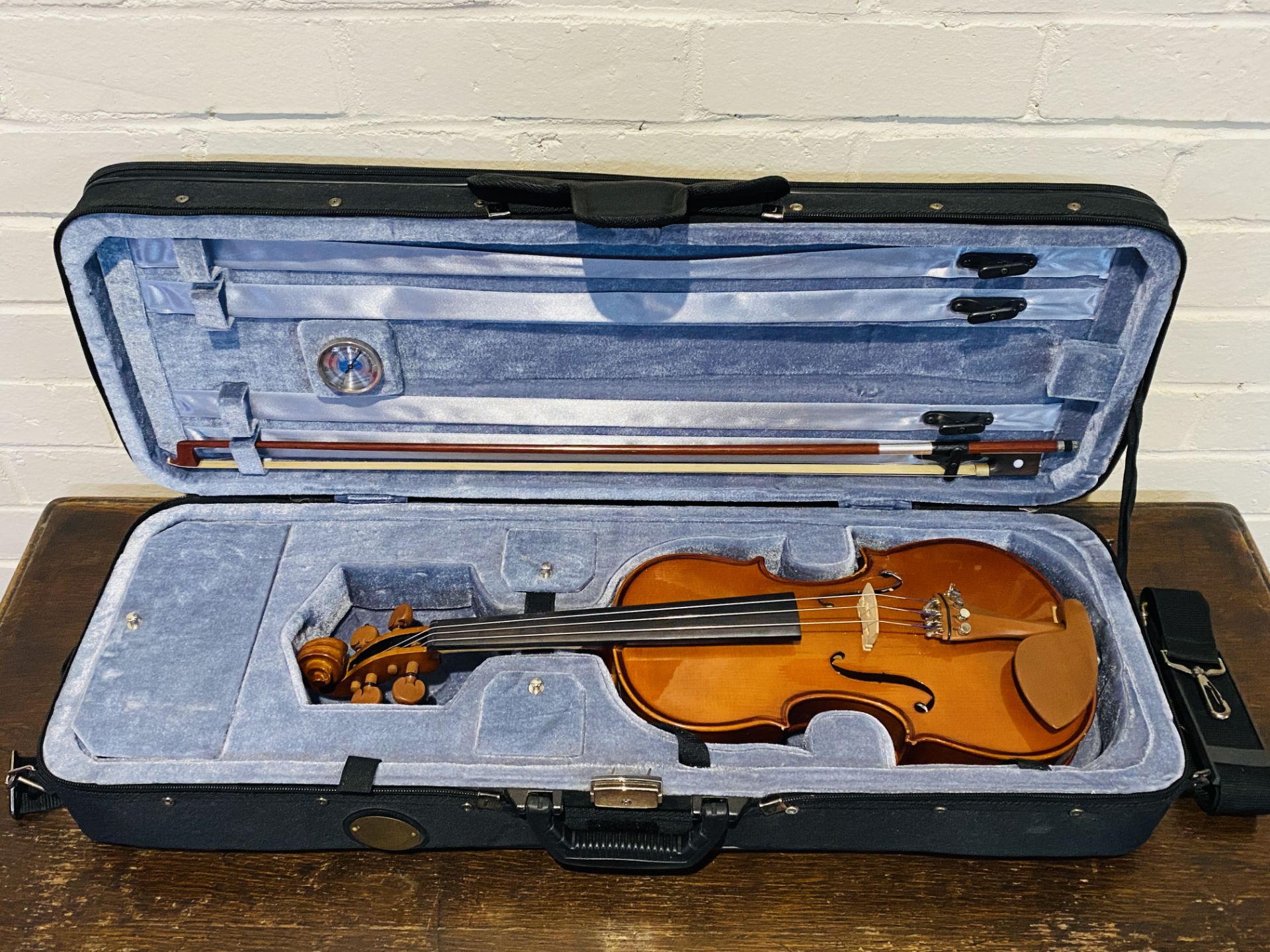 A Cremona violin and bow in travel case
