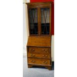 A small Edwardian mahogany and tulipwood inlaid bureau bookcase