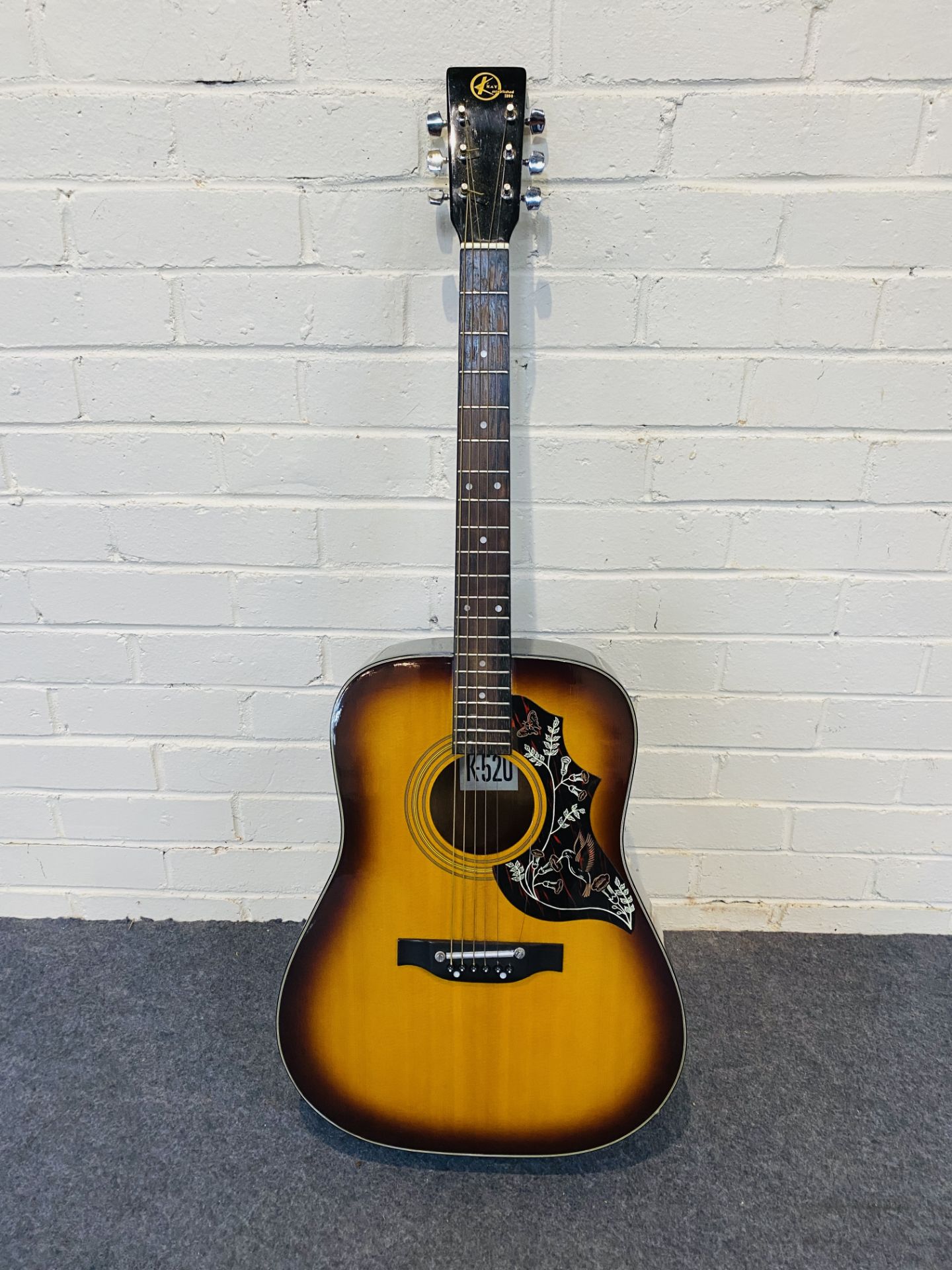 A Kay K-520 six string acoustic guitar with a soft carry case