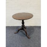An antique mahogany tripod table