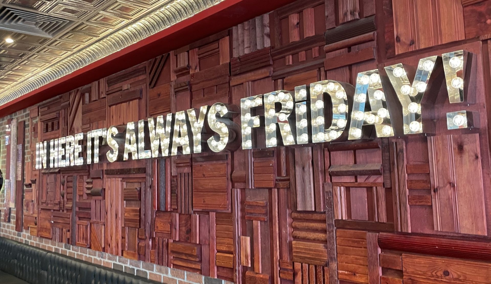 1 x Large-Format Decorative Wall Sign Featuring the Slogan “In Here It's Always Friday!”