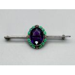 Art Nouveau brooch with a large amethyst and enamel work set in silver, c1920