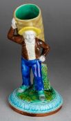 A late 19th Century English Majolica possibly Royal Worcester matchpot figure of a coalman [
