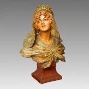 A large 19th century French plaster bust, of an Art Nouveau lady, painted in polychrome, the
