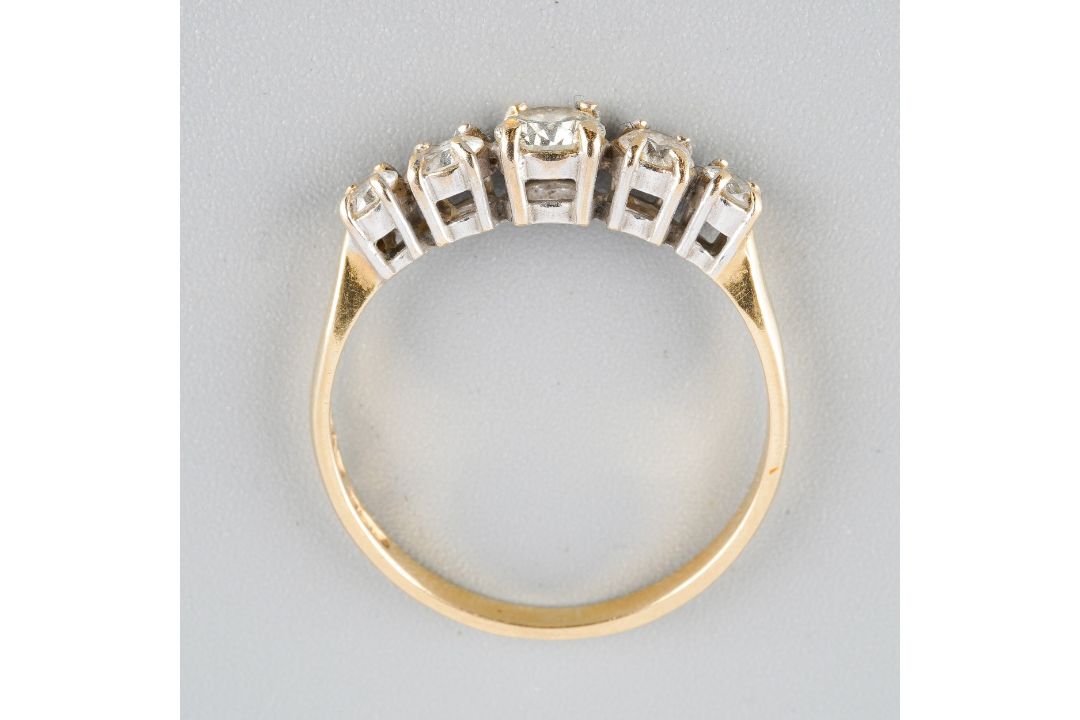 An 18ct gold diamond five stone ring. Set with graduating round ...