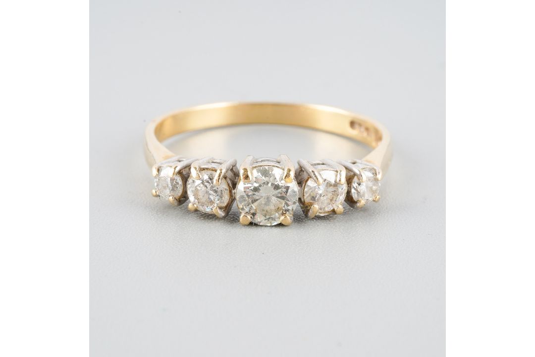 An 18ct gold diamond five stone ring. Set with graduating round ...