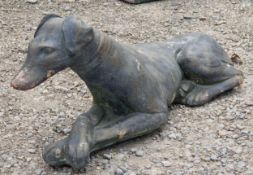 Reconstituted stone bronzed effect statue of a recumbent hound, H 25cm x W 57cm x D 15cm