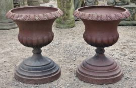 Pair of salt glazed terracotta urns with lobed bowls and flared darted rims, raised on stepped
