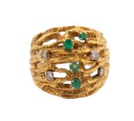 A Continental emerald and diamond abstract bombe ring, the textured open strands sprinkled with four