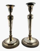 Pair of Regency period Sheffield plated candlesticks, with relief garland and acanthus decoration,