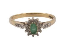 A vintage 9ct gold, emerald and diamond oval cluster ring, centred with a small oval mixed-cut