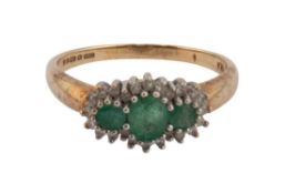A vintage 9ct gold, emerald and diamond triple-cluster dress ring, centred with an oval and two