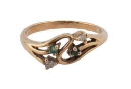 A vintage gold, emerald and diamond four stone open-scroll cross-over ring, claw set with two tiny