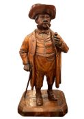 A 19th century Black Forest carved wooden novelty tobacco jar modelled as a gentleman with smoking