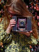 An early No. 4 cartridge Eastman Kodak folding 104 roll-film camera. Black leatherette outer case