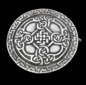 Alexander Ritchie, an Arts and Crafts Iona silver clasp, cast in relief as a circular shield with