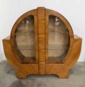 A 1930's, Art Deco, walnut display cabinet, with cloud-shaped glazing bar, two internal glass