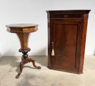 A late 19th century figured walnut work table: octagonal top over trumpet form box on turned, carved
