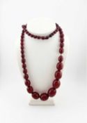 A graduated cherry red bakelite bead necklace