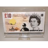 Banksy, Dismal 10 Pound Canvas, Multiple von 2015, Dismaland, unter Plexiglas
