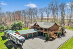 Outstanding Log Home With Attached 3 Car Garage.