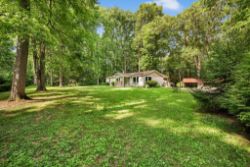 RANCH HOME ON 11.9 WOODED ACRES W/ POND & STREAM