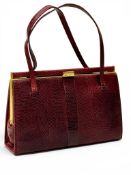 A Mappin & Webb Red Lizard Hand Bag. C.1960. 24.5x716cm.